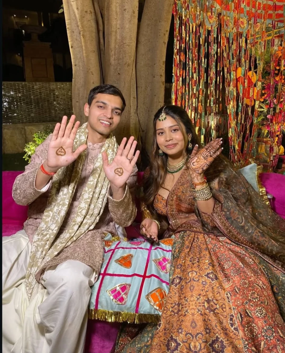Couple displaying celebration mehndi