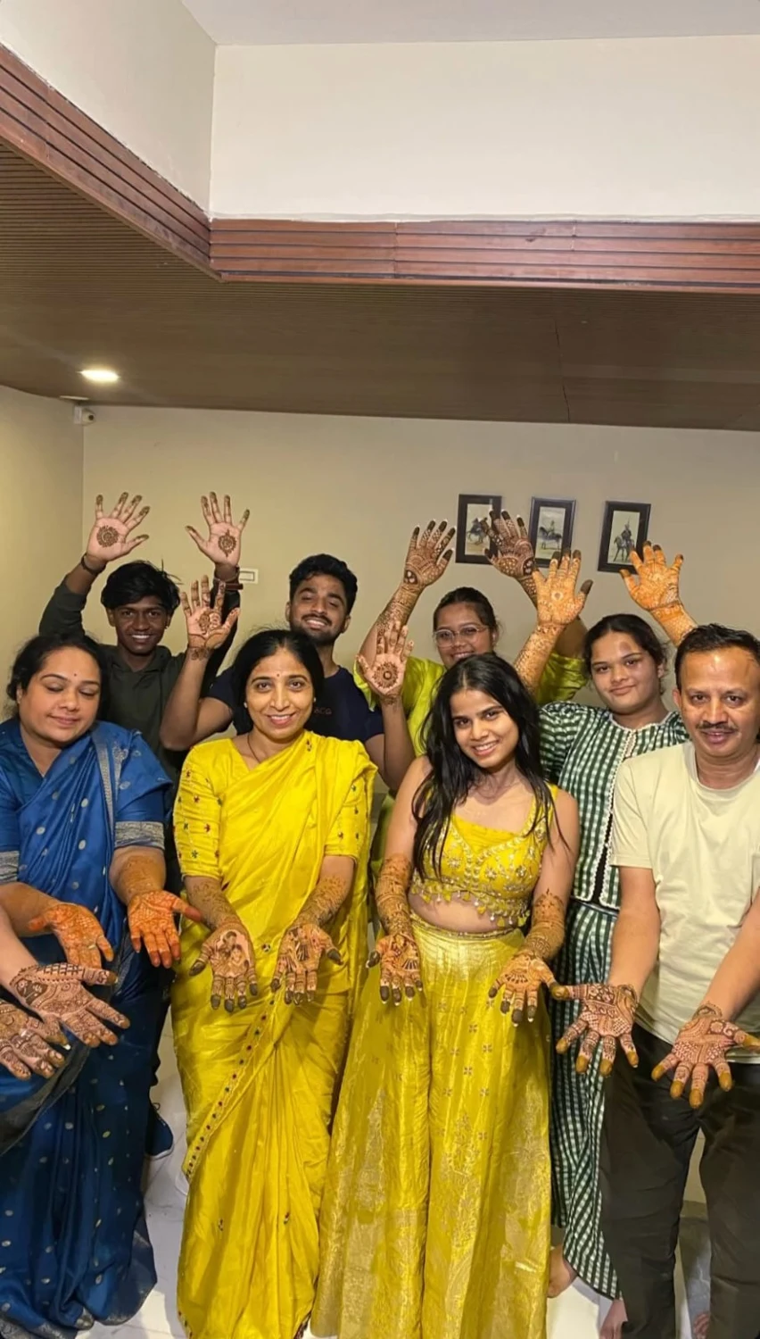 Guests displaying mehndi at a group celebration