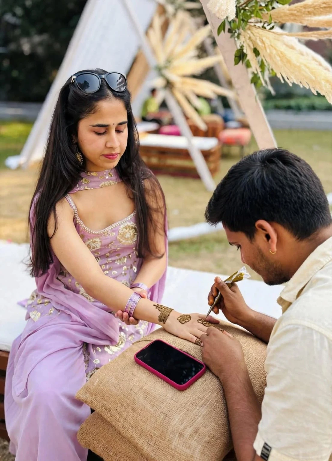 Mehndi artist carefully applying a hand design